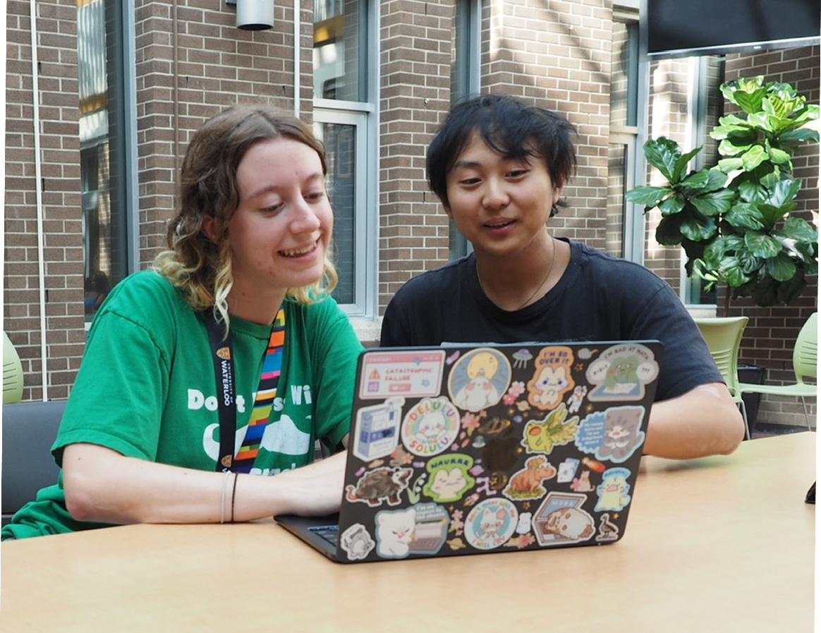 Two students reviewing feedback together on a laptop