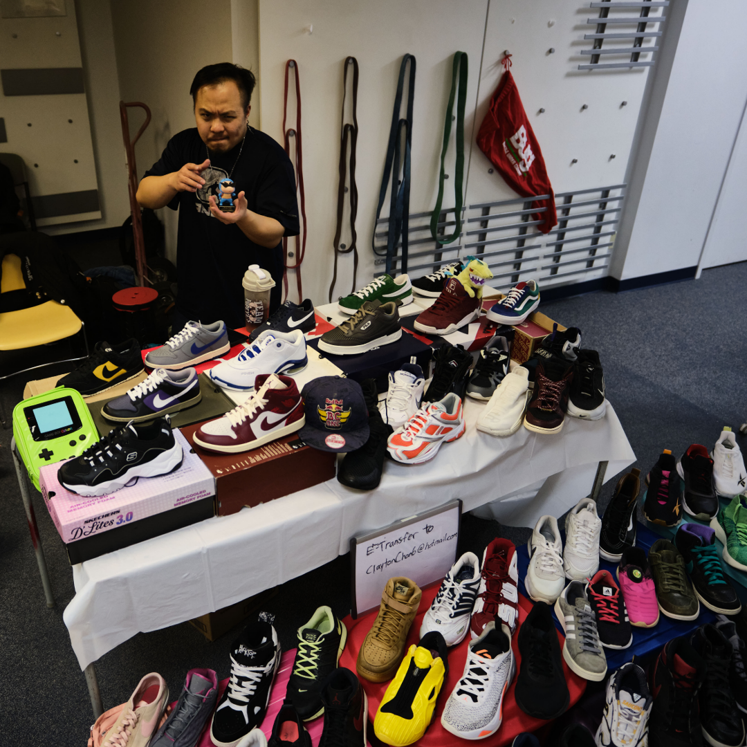 A vendor table selling streetwear and shoes